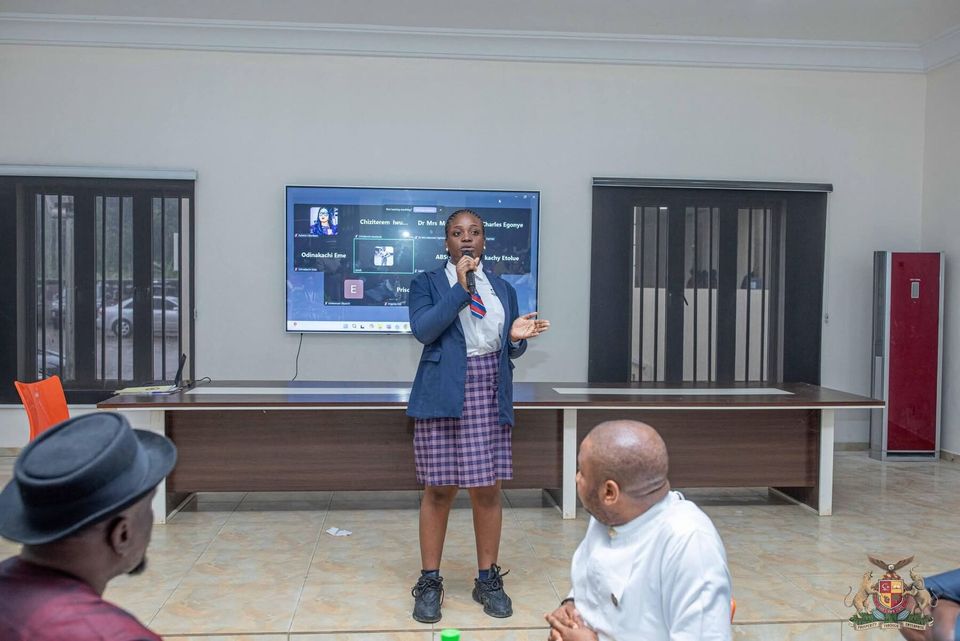 Officials and a student at a presentation event, July 2025